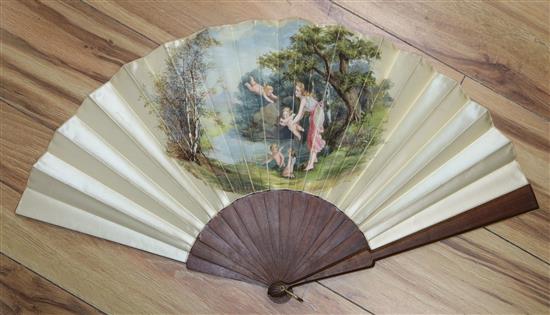 A late 19th/early 20th century fan, the silk leaf painted with a classical scene of a maiden and cupids